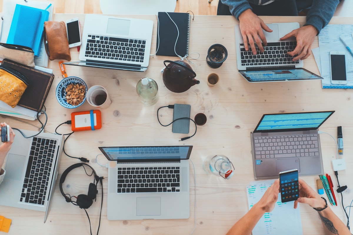 Laptops and devices on a shared desk during a working session