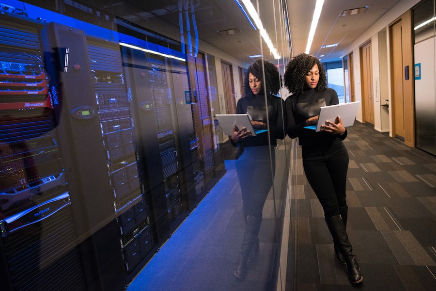 Engineers walking through a data centre aisle